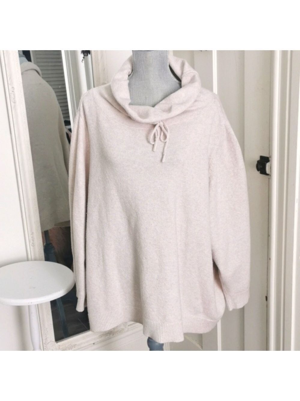 In every story.... cream athletic cowl neck sweater. Size 5XL
